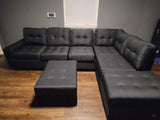 Black linen reversible tufted sectional with drop down cup holders and storage ottoman