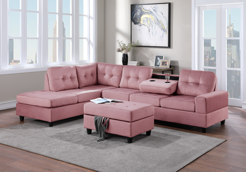 Pink velvet reversible tufted sectional with drop down cup holders and storage ottoman