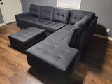 Black linen reversible tufted sectional with drop down cup holders and storage ottoman