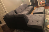 Grey reversible microfiber sectional with drop down cup holders and storage ottoman