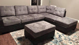 Grey reversible microfiber sectional with drop down cup holders and storage ottoman